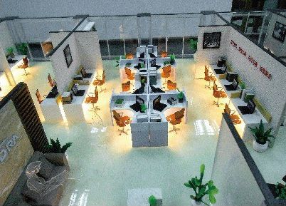 Cutaway model of an open-plan office with internal lighting and planting