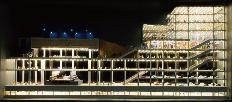 Cutaway model of a shopping centre over several floors with internal lighting