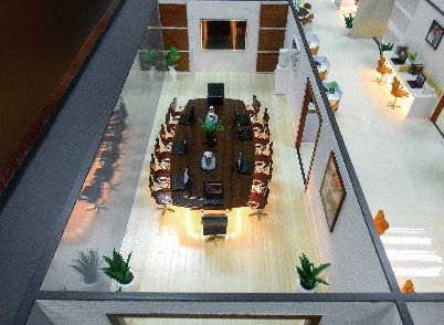 Cutaway model of a large boardroom surrounded by offices