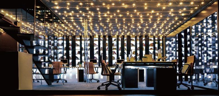 Cutaway model of an office with a lit star ceiling and library walls