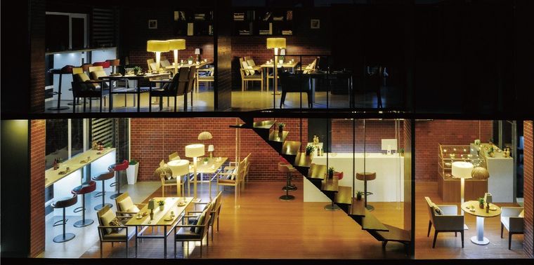 Cutaway model of a restaurant over two floors with internal lighting