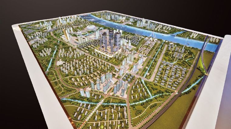 Complete city master plan model on a white table with roads and districts
