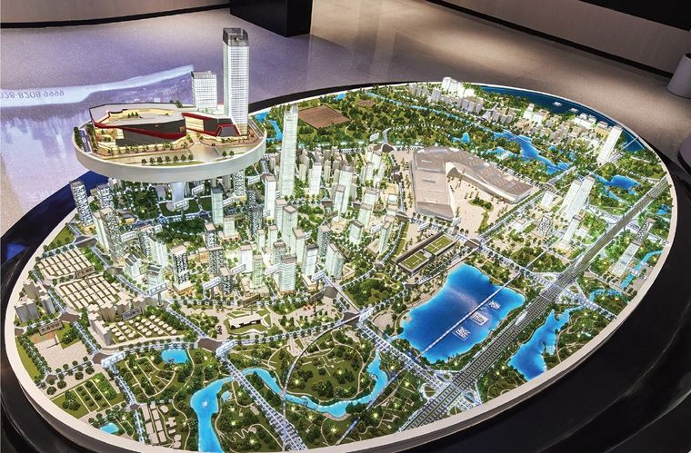 Model of a city on a large circular base with the lakes and high ground
