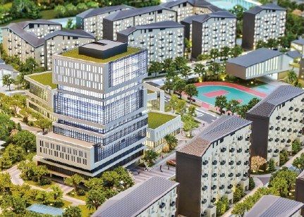 Close view of an administrative tower among residential buildings and sports pitches