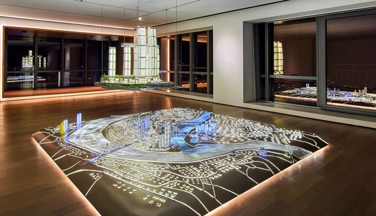 Illuminated city master plan in a showroom with supporting models