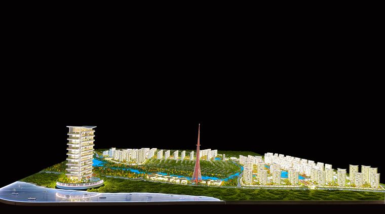Long waterfront plan lit at night with a landmark tower