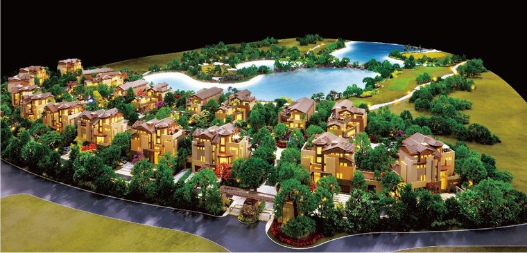 Model of a hillside residential resort around a lake under warm light