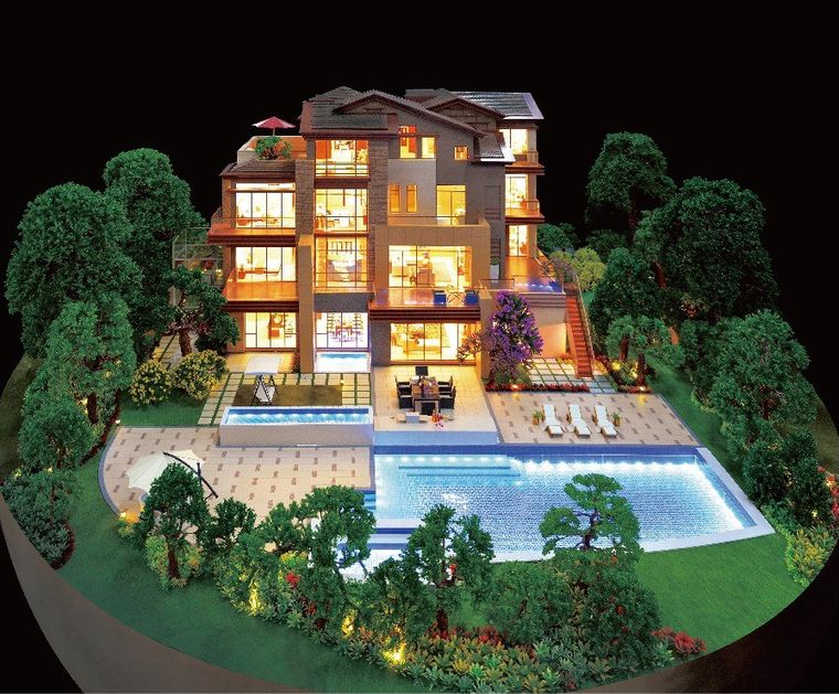 Model of a villa with a garden, pool and full internal lighting