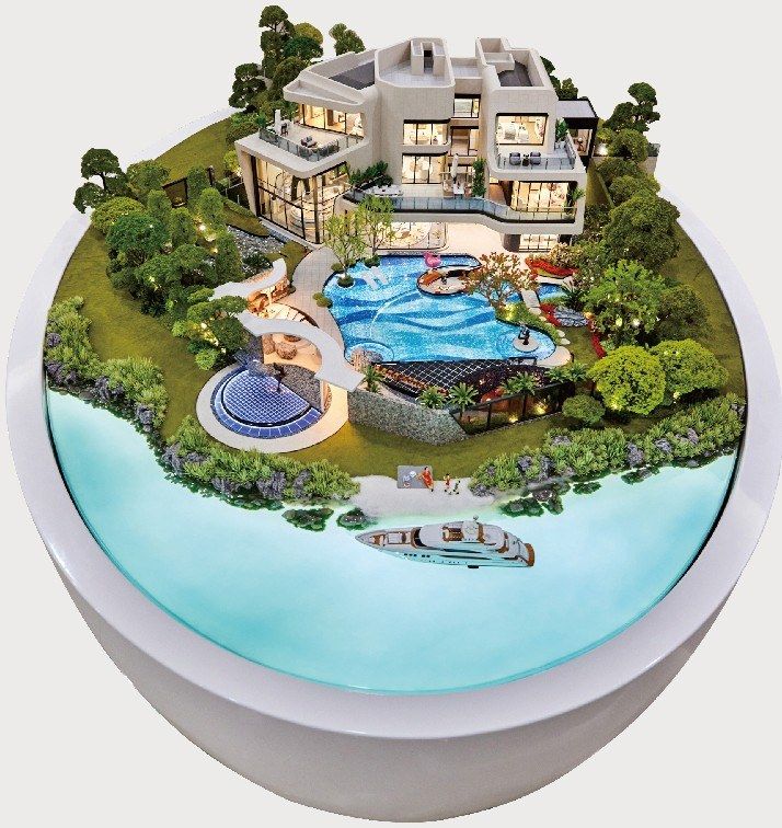 Model of hillside villas with pools and gardens on a white base