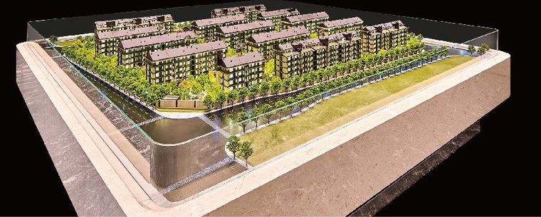 Model of a district of villas with green roofs on a marble base
