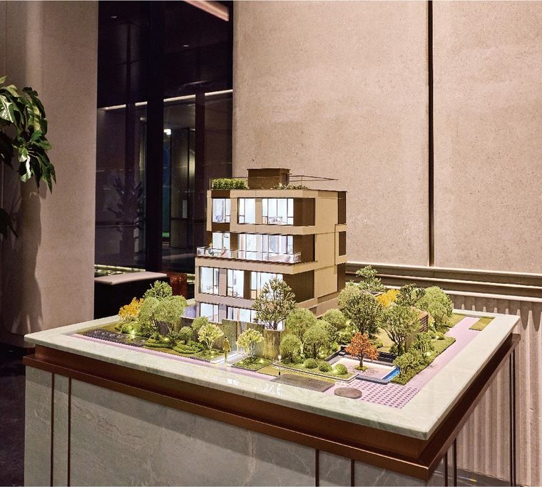 Model of a contemporary villa with the garden and pool on a display table