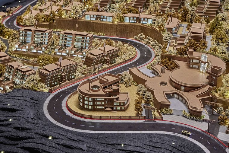 Aerial view of a villa community with paths and green space